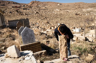 22/02/2017 - Khana Sor, Iraq: Jalal Haskany visits the grave of his uncle who lost his life while he tried to pass the Aegan Sea from Turkey to Greece in a boat. The Yazidi people have their own graveyards of their tribe where the deceased get buried.